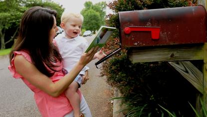 Child receiving book from Imagination Library